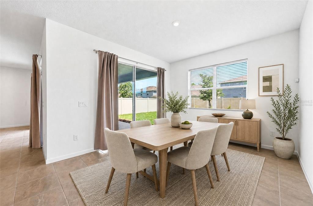 A dining room features a wooden table, six chairs, a sideboard, and a sliding glass door — 891 HONEY PETAL LANE, DELAND, FL