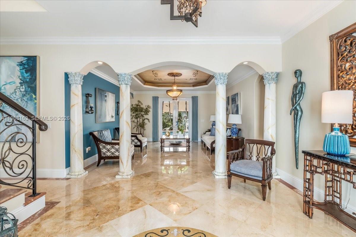 A grand foyer features marble floors, decorative columns, and a tray ceiling with a chandelier — 7851 NW 166th Ter, Miami Lakes FL 33016, MIAMI LAKES, FL