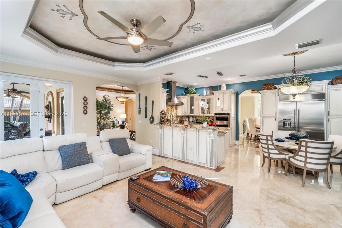 A living room and kitchen area with white cabinetry, a coffered ceiling, and tile flooring — 7851 NW 166th Ter, Miami Lakes FL 33016, MIAMI LAKES, FL