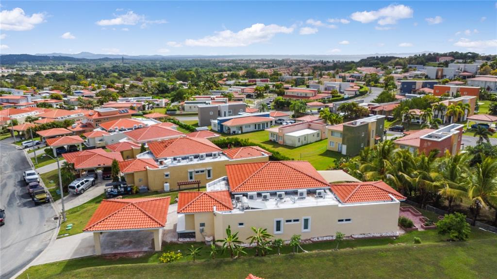 An aerial view of a suburban neighborhood featuring houses with orange tile roofs — Palmas del Mar THE VIEWS # 12, HUMACAO, PR