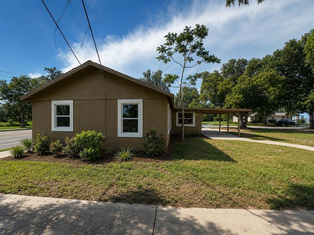 A tan, single-story house with a carport and a small front yard — 1907 S RIO GRANDE AVENUE, ORLANDO, FL