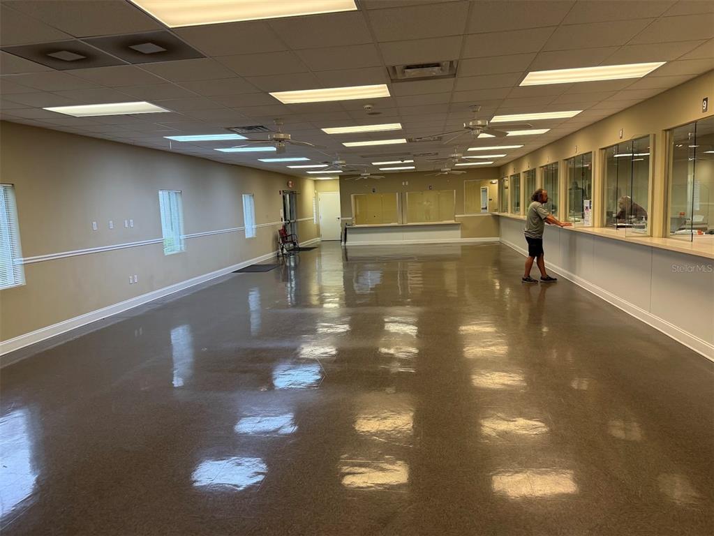 An office hallway features a row of individual workstations with glass partitions and carpeted flooring — 5431 E SILVER SPRINGS BOULEVARD UNIT C, SILVER SPRINGS, FL