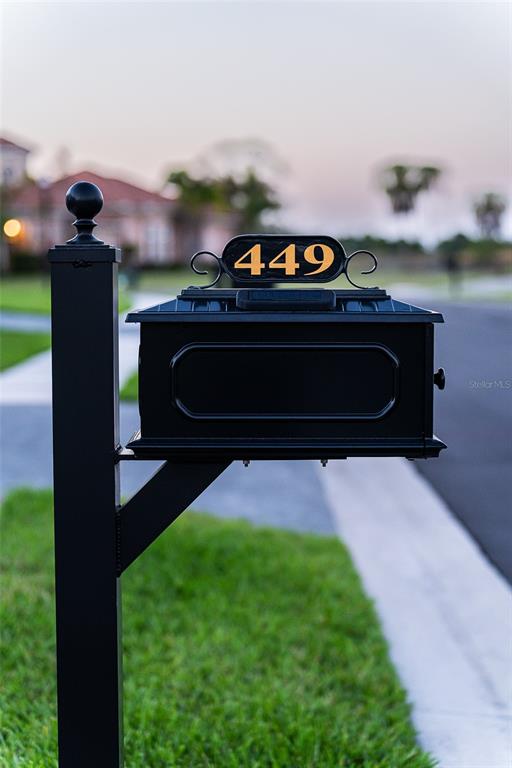 A black metal mailbox with the house number 449 stands on a post by a street — 449 SE FASCINO CIRCLE, PORT ST LUCIE, FL