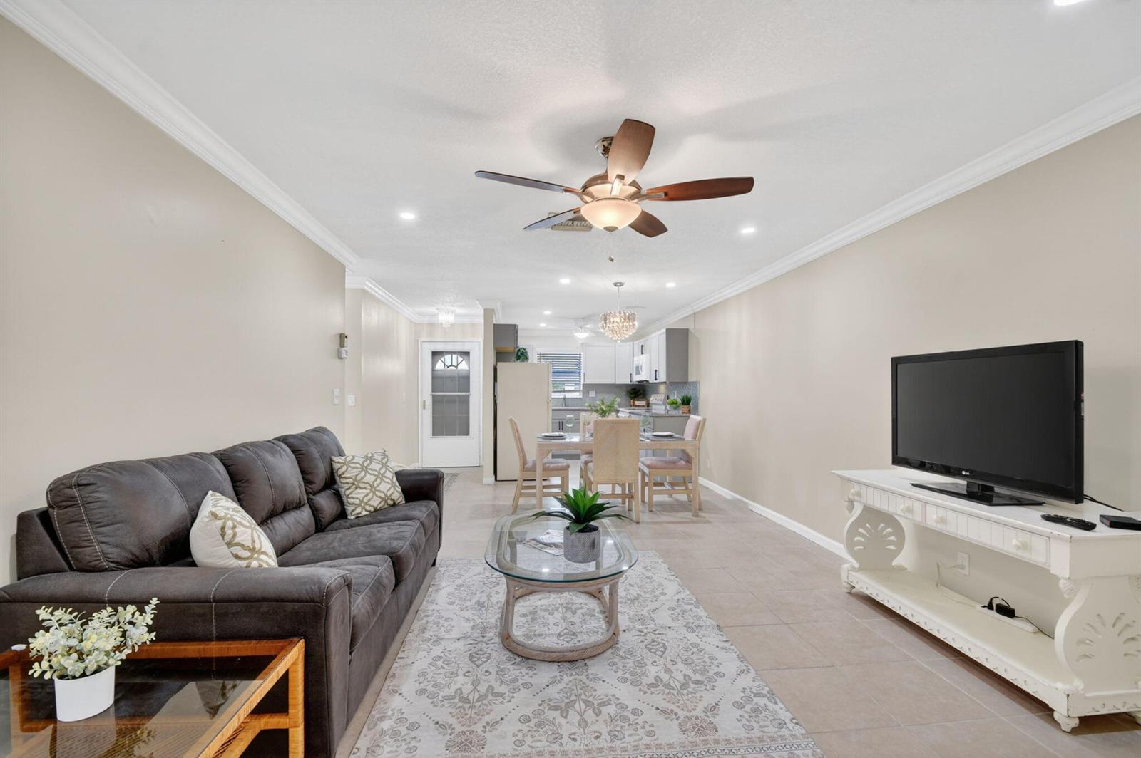 A living room and dining area with tile floors, a ceiling fan, and neutral walls — 2787 Dudley Dr Apt D, West Palm Beach FL 33415, WEST PALM BEACH, FL