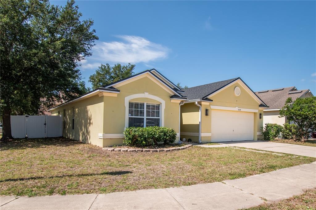 A dining room features a dark wood table, gray chairs, and a geometric room divider — 5049 GANDROSS LANE, MOUNT DORA, FL