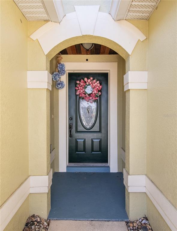 A kitchen features white cabinets, granite countertops, stainless steel appliances, and a large center island — 5049 GANDROSS LANE, MOUNT DORA, FL