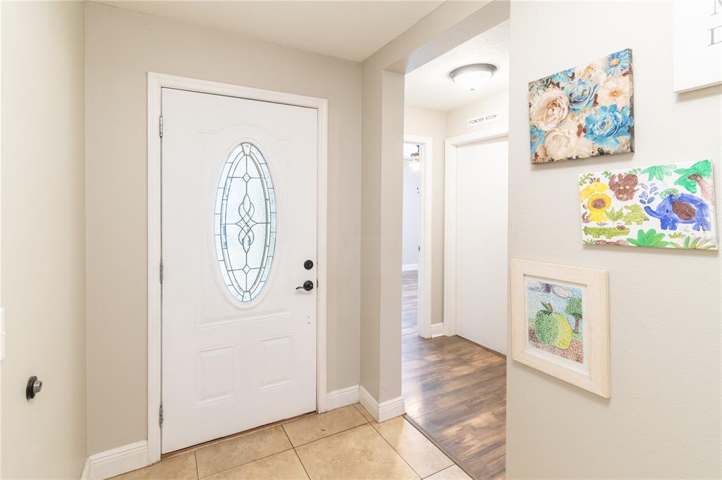 A dining area with a dark wood table and chairs sits on a patterned rug — 5049 GANDROSS LANE, MOUNT DORA, FL