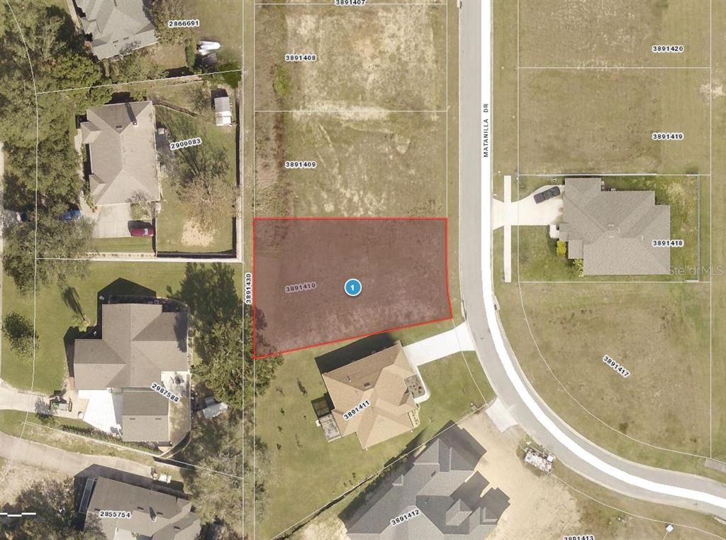 This is an aerial map view of a vacant residential lot highlighted in red — 11619 MATANILLA DRIVE, CLERMONT, FL