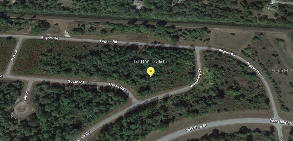 This aerial map view shows a vacant, wooded residential lot located at a street intersection — Lot 14 LORING DRIVE, NORTH PORT, FL