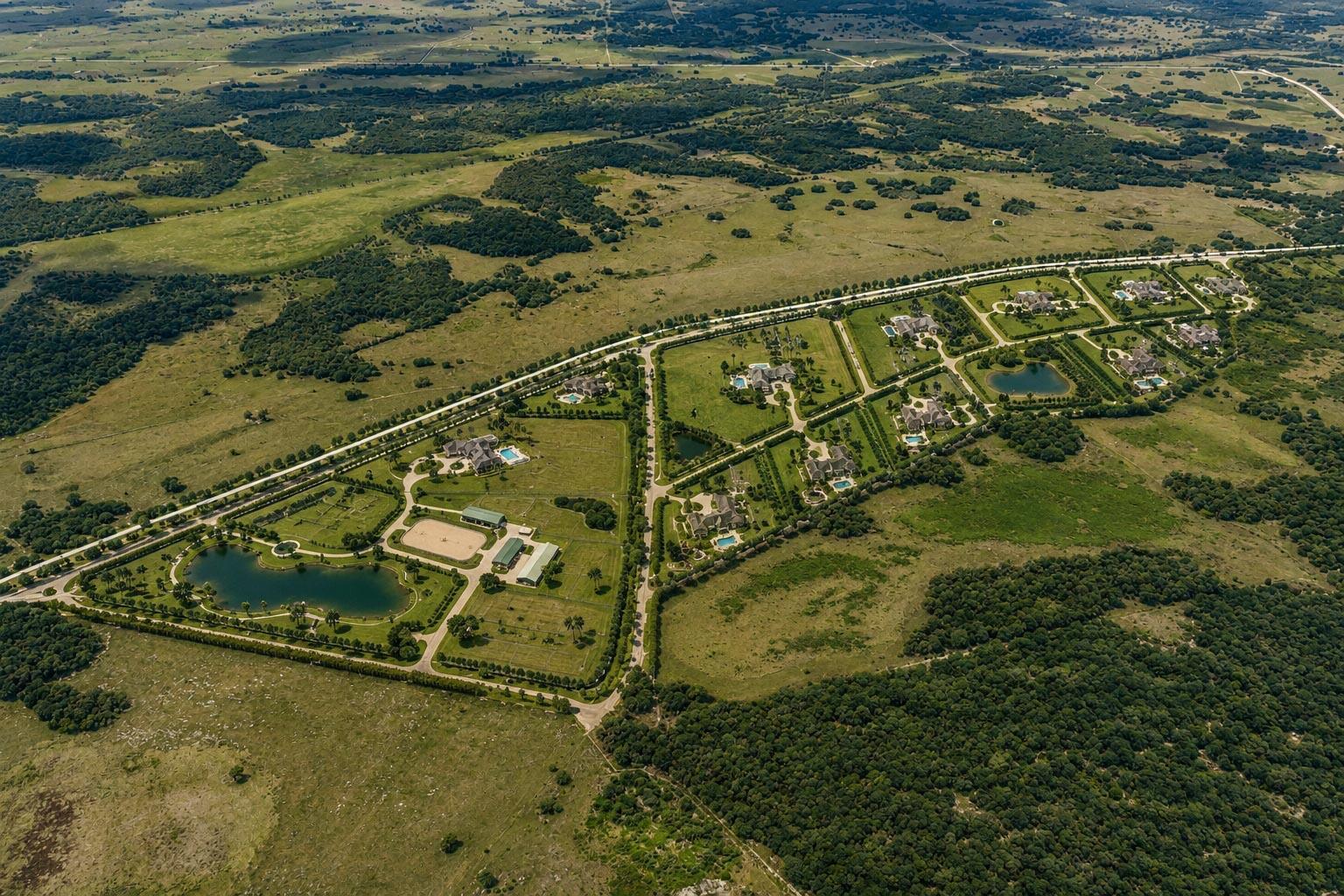 An aerial view shows a rural residential development with large estates, ponds, and green pastures — 0000 Hill Grade Road, Clewiston FL 33440, CLEWISTON, FL