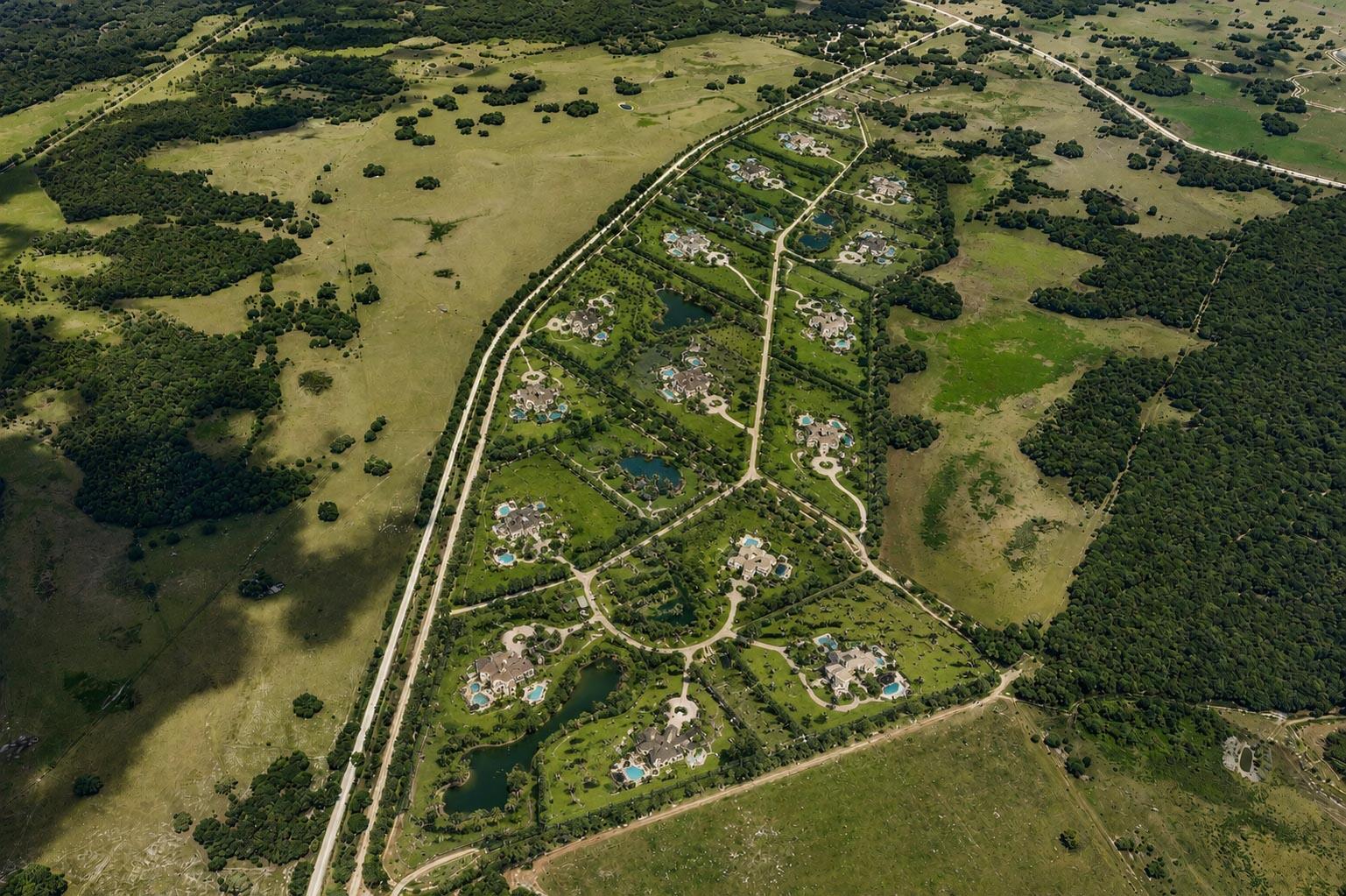 Aerial view of a rural residential development featuring large homes with pools on expansive lots — 0000 Hill Grade Road, Clewiston FL 33440, CLEWISTON, FL