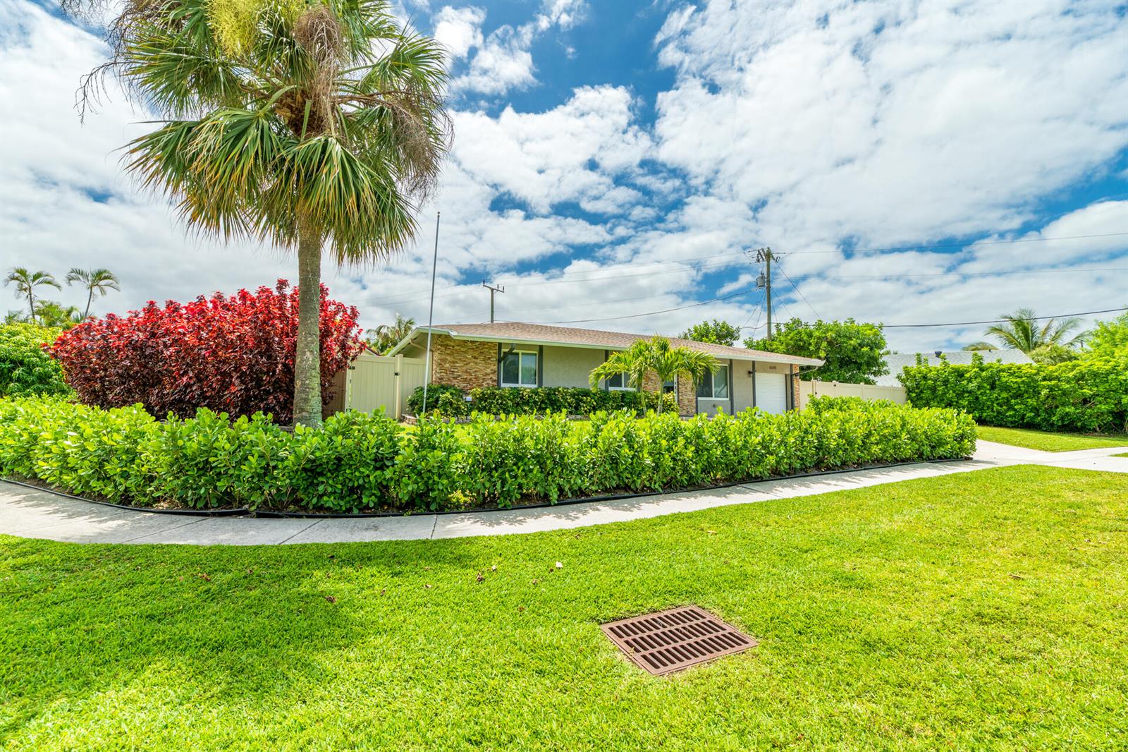 A single-story house with a stone facade, a palm tree, and a manicured hedge — 8099 Santa Fe Trail, Boca Raton FL 33487, BOCA RATON, FL