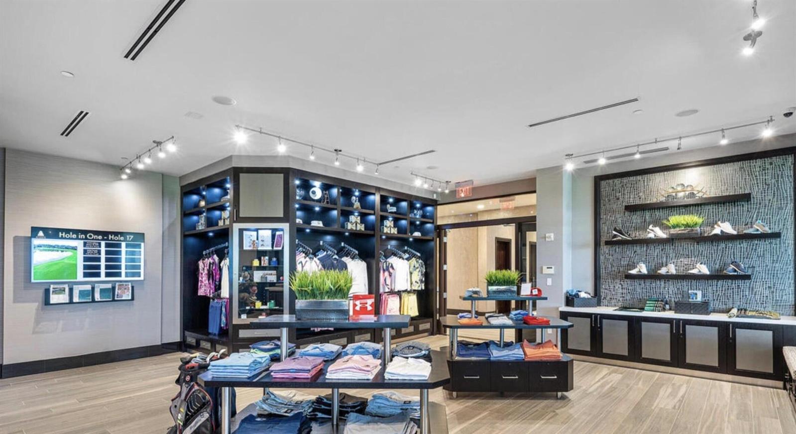 A modern golf pro shop displays apparel, footwear, and accessories on shelves and tables — , West Palm Beach FL 33411, WEST PALM BEACH, FL