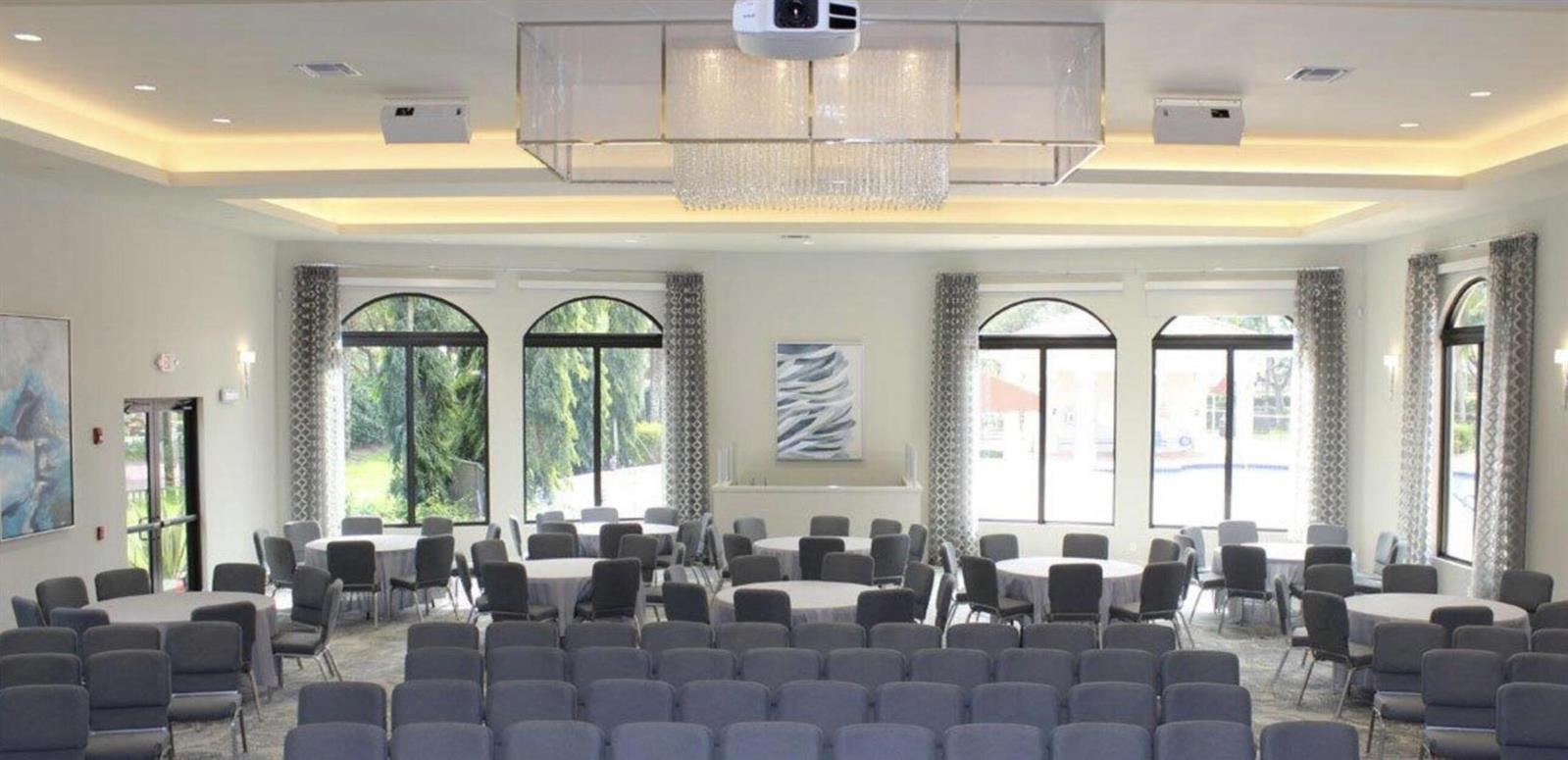 A large event room features rows of gray chairs, round tables, and a crystal chandelier — , West Palm Beach FL 33411, WEST PALM BEACH, FL