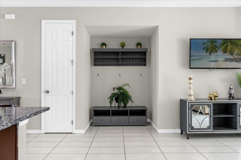 A living room features a recessed wall with shelving, a media console, and tile flooring — 1540 CAREY PALM CIRCLE, KISSIMMEE, FL