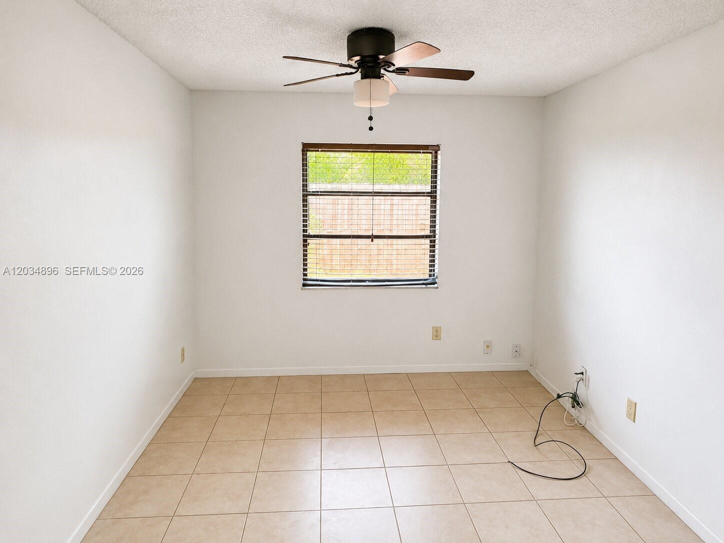 A room with white walls, a ceiling fan, a window, and light-colored tile flooring — 3819 SW 69th Ave # L, Miramar FL 33023, MIRAMAR, FL