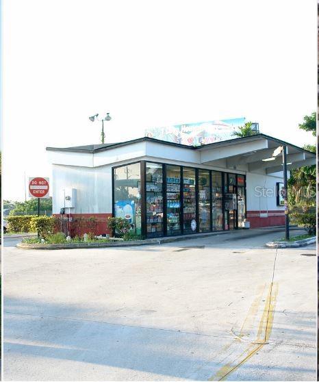 A single-story commercial building with a glass storefront and a covered drive-through area — 4050 SW 21ST STREET, FORT LAUDERDALE, FL