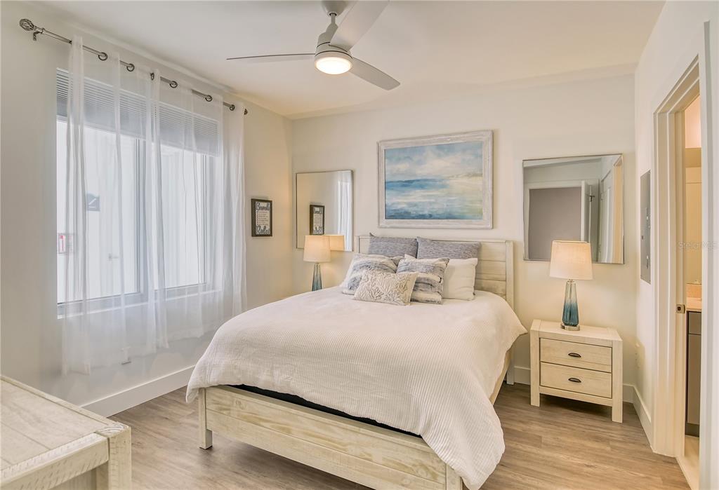 A bedroom features a queen bed, two nightstands with lamps, and a ceiling fan — 1709 N TAMIAMI TRAIL UNIT 221, SARASOTA, FL