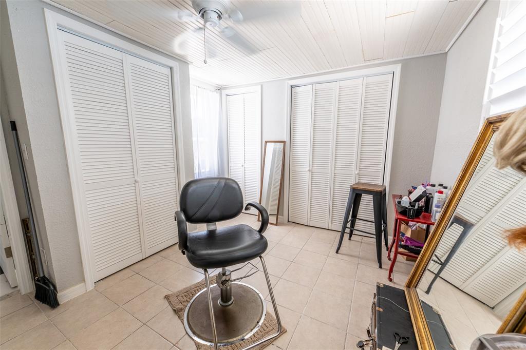 A kitchen features white cabinets, butcher block countertops, white appliances, and light-colored terrazzo flooring — 185 WINSON AVENUE, ENGLEWOOD, FL