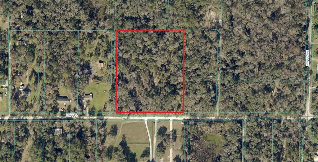 An aerial view shows a rectangular, wooded plot of land outlined in red — 12191 NW 7TH PLACE, OCALA, FL