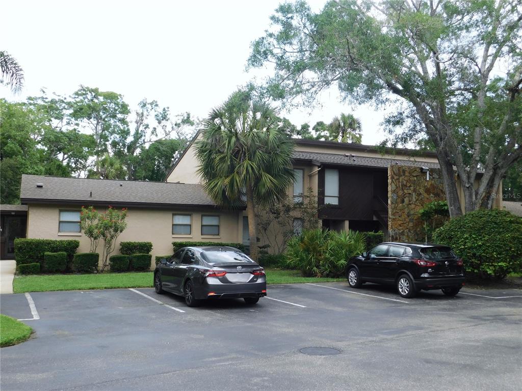 A two-story apartment building with a stone facade and parking lot in front — 1400 TARPON WOODS BOULEVARD UNIT 1-4, PALM HARBOR, FL