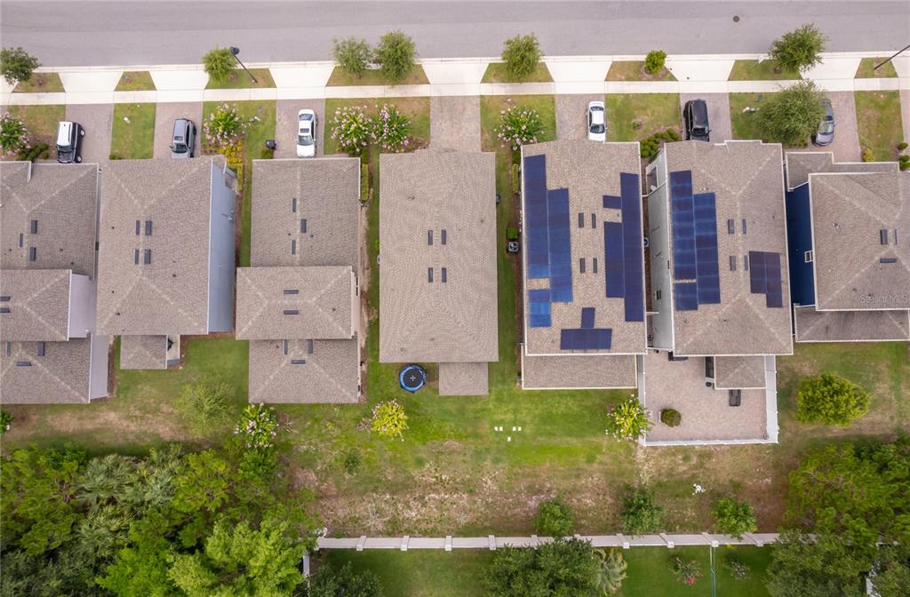 Aerial view of a row of suburban houses with driveways and a shared backyard area — 2229 EMERALD SPRINGS, APOPKA, FL