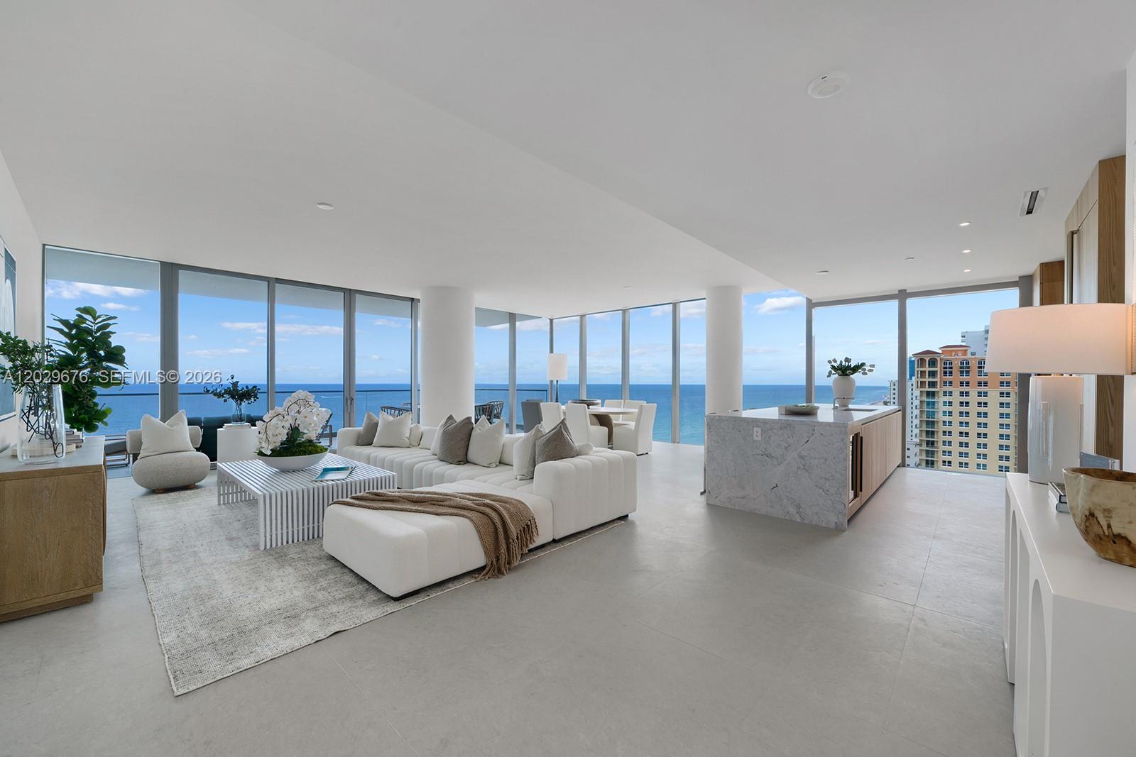 A bright, open-concept living area features floor-to-ceiling windows with ocean views and a marble island — 2000 S Ocean Dr # 15B, Hallandale Beach FL 33009, HALLANDALE BEACH, FL