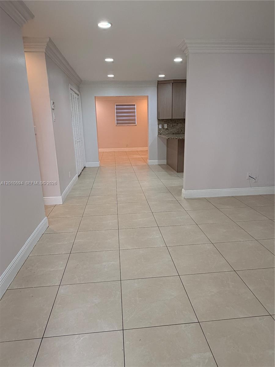 A tiled floor leads from a living area toward a kitchen and a back room — 3011 N 74th Ave, Hollywood FL 33024, HOLLYWOOD, FL