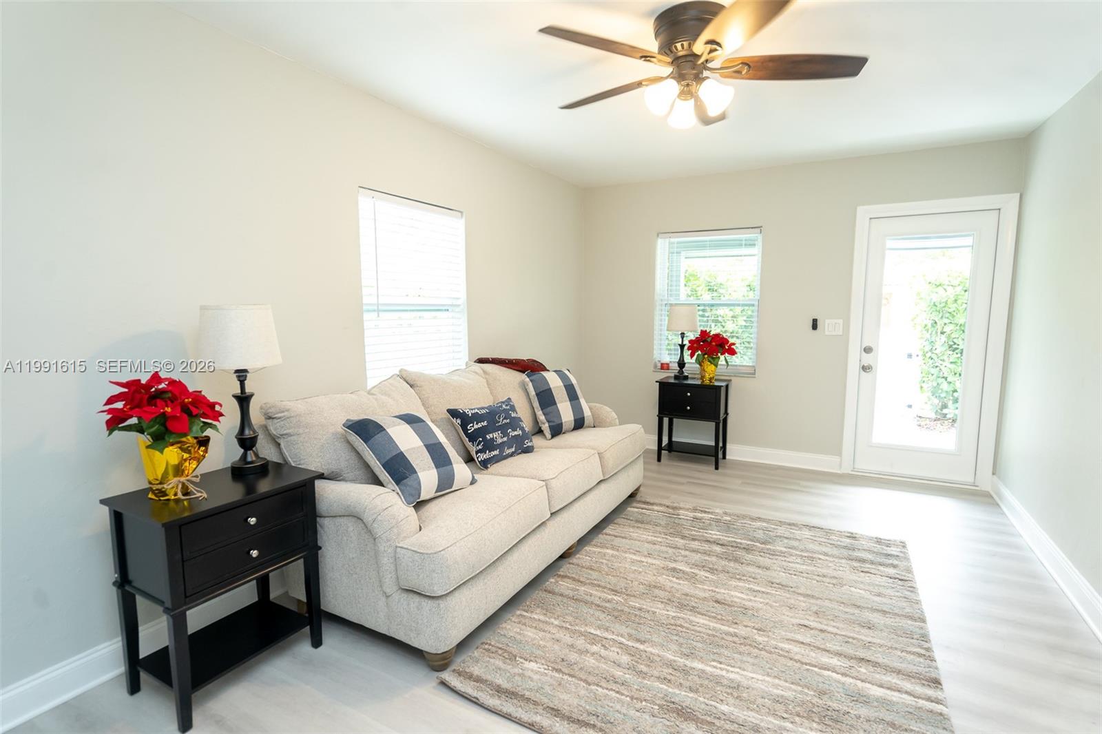 A living room features a beige sofa, two black end tables, and a ceiling fan — 2230 SW 60th Ct, Miami FL 33155, MIAMI, FL