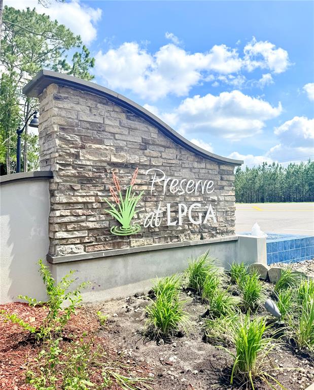 A stone monument sign for Preserve at LPGA stands in a landscaped garden area — 5135 MAGNOLIA DRIVE, DAYTONA BEACH, FL