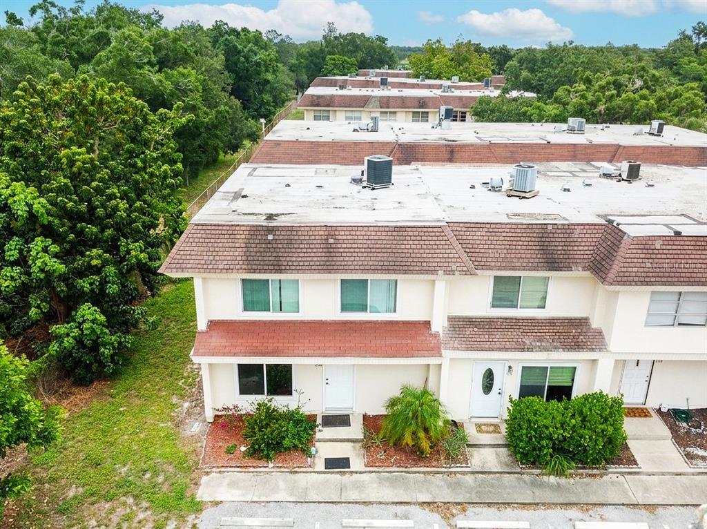 An aerial view of a two-story townhouse complex with white walls and brown roofs — 309 AMHERST AVENUE UNIT 51, SARASOTA, FL