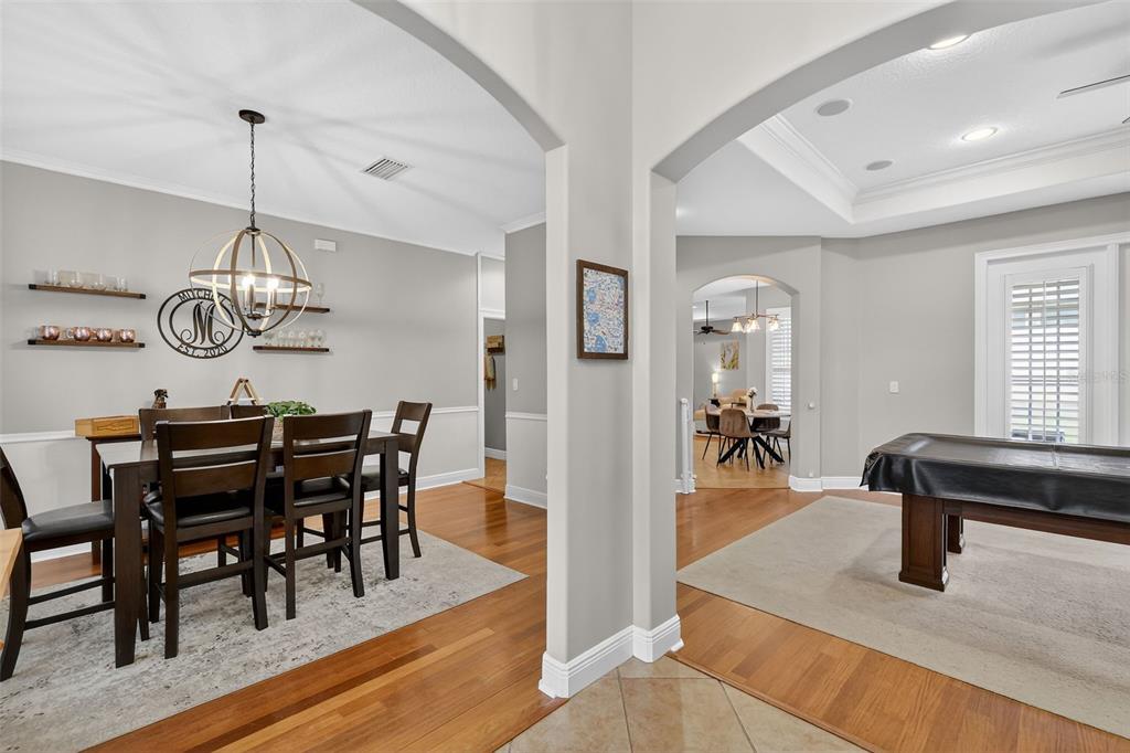 A dining room with a wooden table and a game room with a pool table — 1245 SHORECREST CIR, CLERMONT, FL