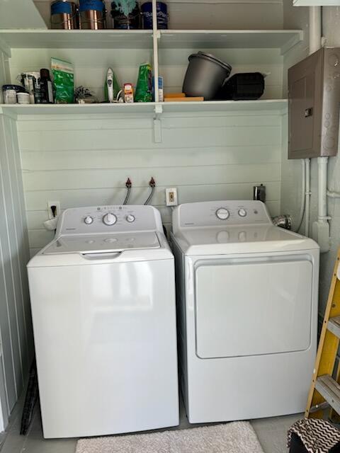 A laundry room features a white washer and dryer beneath open shelving and a breaker box — 4404 SE Mulford Lane, Stuart FL 34997, STUART, FL