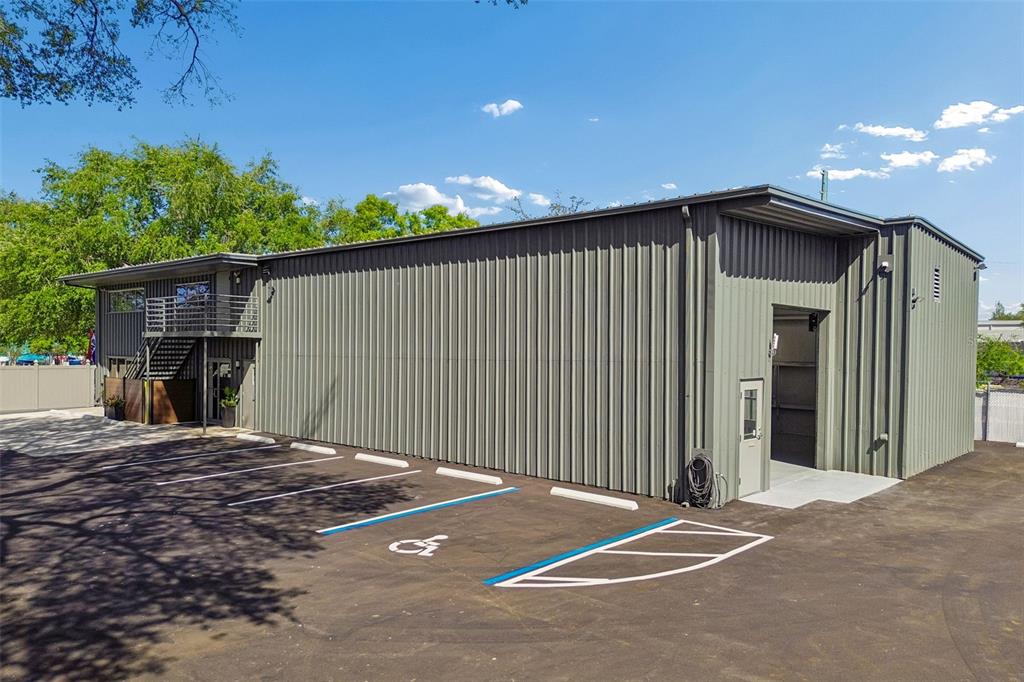 A metal-sided commercial building features a parking lot with a designated handicap space — 1453 S MARTIN LUTHER KING JR AVENUE, CLEARWATER, FL
