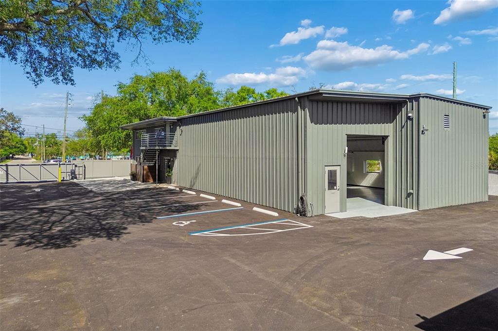 A gray metal warehouse building with a parking lot and a fenced entrance — 1453 S MARTIN LUTHER KING JR AVENUE, CLEARWATER, FL