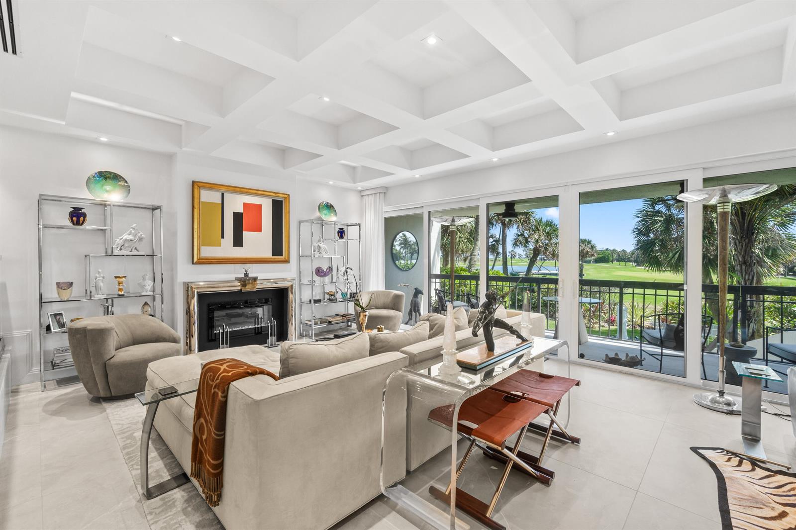 A bright living room features a coffered ceiling, fireplace, and sliding doors overlooking a golf course — 2335 S Ocean Boulevard # C9, Palm Beach FL 33480, PALM BEACH, FL