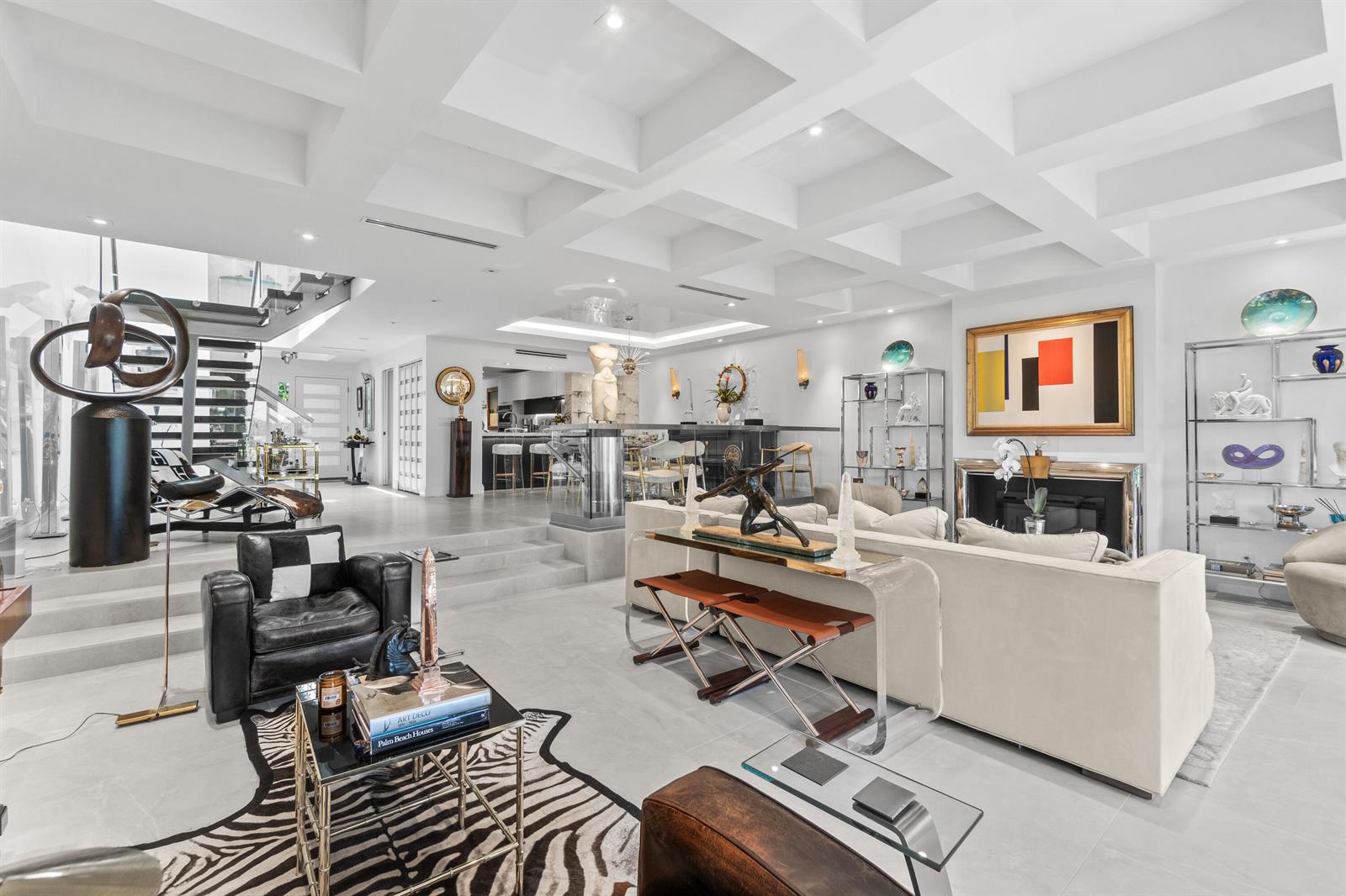A spacious, modern living room features a coffered ceiling, a fireplace, and eclectic decor — 2335 S Ocean Boulevard # C9, Palm Beach FL 33480, PALM BEACH, FL