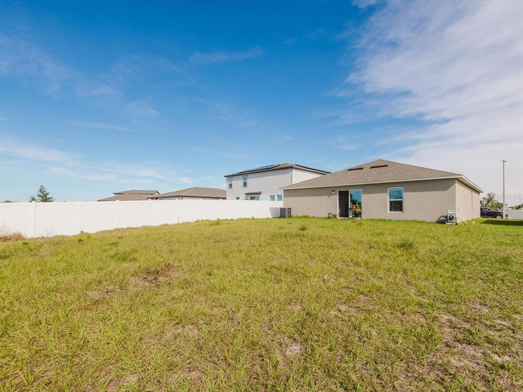 A child's bedroom features a white loft bed, a small table, and a play area — 288 TOWNS CIRCLE, HAINES CITY, FL