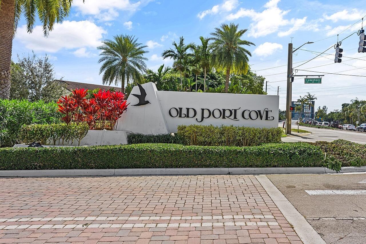 A white monument sign for Old Port Cove stands near a palm-lined road intersection — 100 Lakeshore Drive # 252, North Palm Beach FL 33408, NORTH PALM BEACH, FL