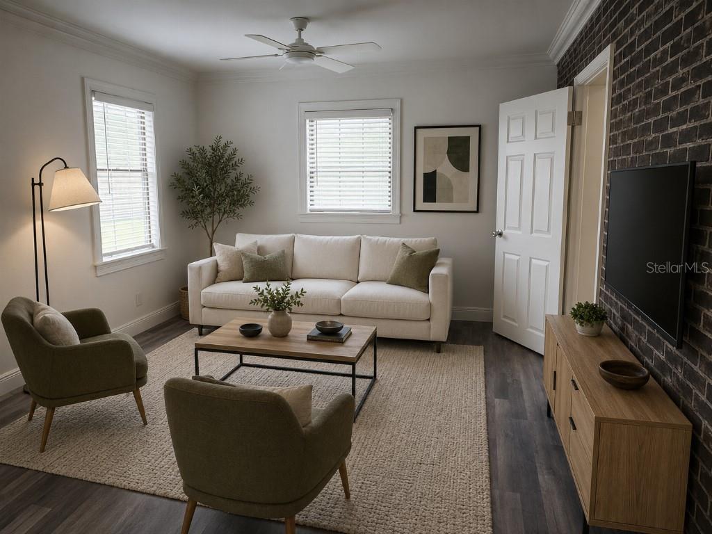A living room features a white sofa, two olive chairs, a brick wall, and wood flooring — 1005 N BRACEWELL DRIVE, PLANT CITY, FL