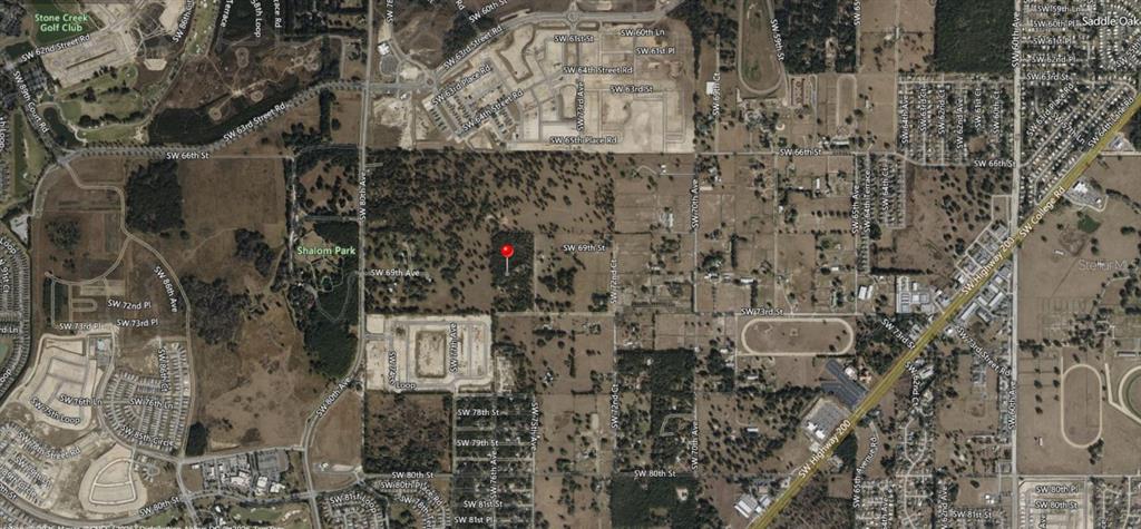 This is an aerial map view showing a plot of land marked with a red pin — 7589 SW 73RD STREET, OCALA, FL