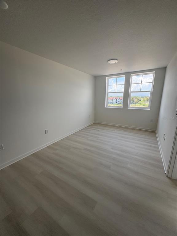 A white door with a peephole and silver hardware is labeled with the number 506 — 5579 MILLENIA PARK BOULEVARD UNIT 506, ORLANDO, FL