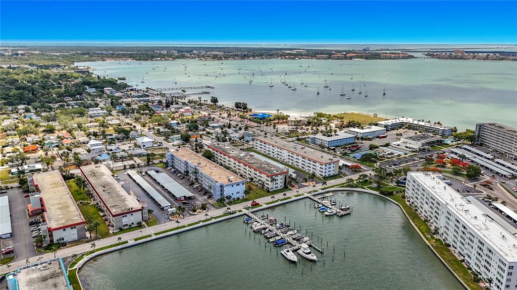 An aerial view shows apartment buildings, a boat marina, and a bay with many boats — 3018 59TH STREET S UNIT 102, GULFPORT, FL
