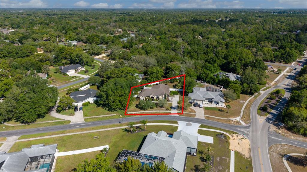 An aerial view shows a single-story house with a red outline on a suburban lot — 13189 JESSICA DRIVE, SPRING HILL, FL