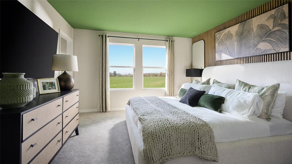 A bedroom features a green ceiling, a textured headboard, and a dresser facing a window — 9150 BENT BRANCH, DADE CITY, FL