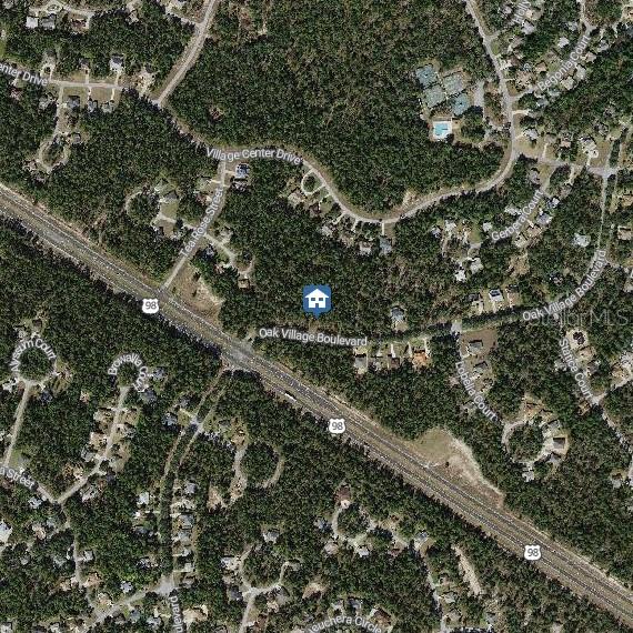 This is an aerial map view of a wooded residential area along Highway 98 — 11 OAK VILLAGE BOULEVARD, HOMOSASSA, FL