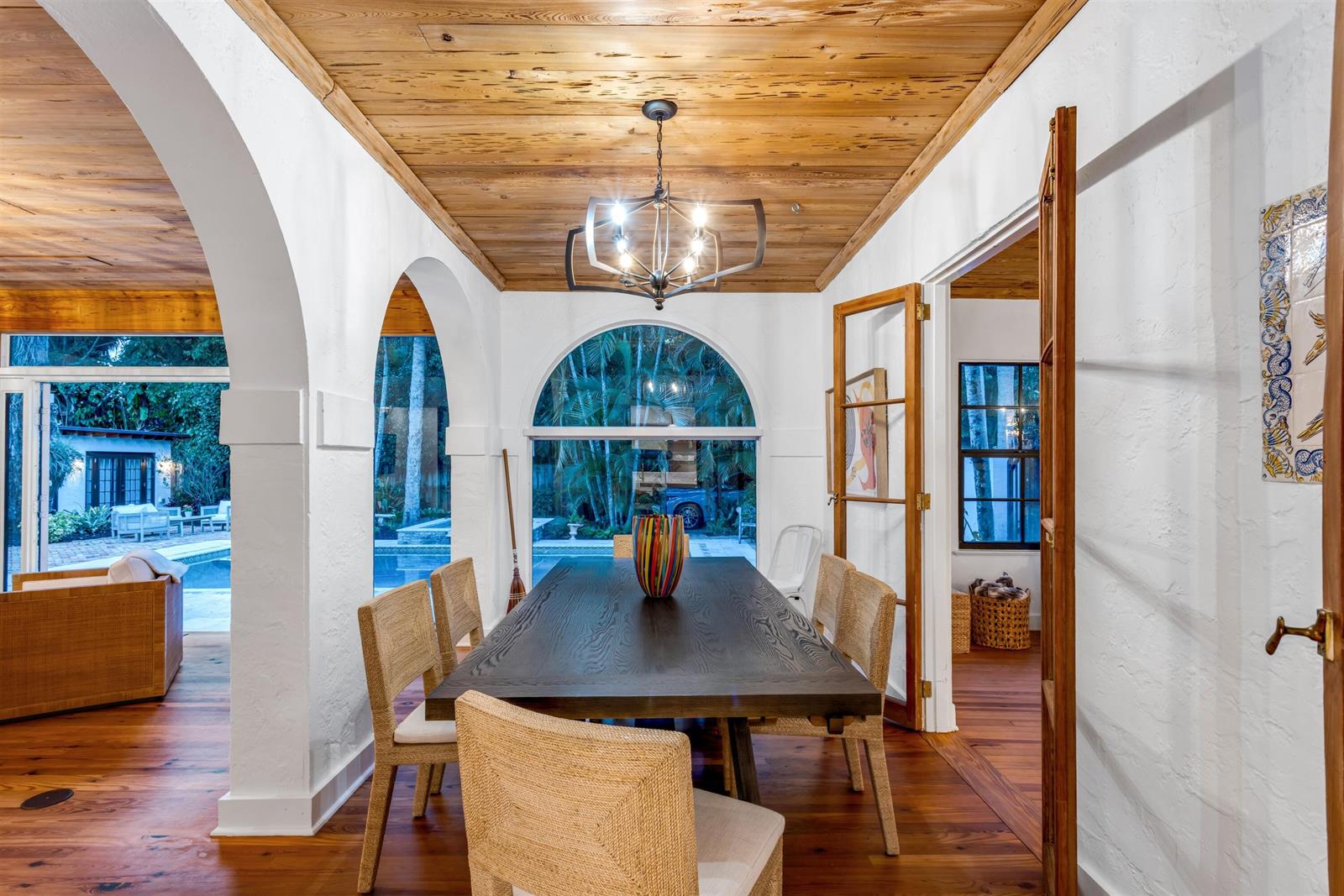 A dining room features a dark wood table, woven chairs, and a vaulted wood ceiling — 755 Alamanda Street, Boca Raton FL 33486, BOCA RATON, FL