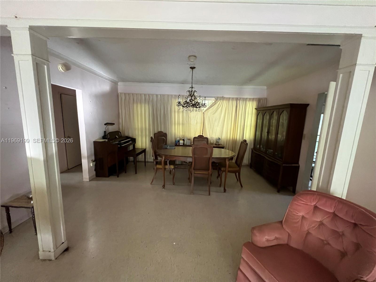 A dining room features a wooden table, chairs, a hutch, and a piano — 812 Columbus Blvd, Coral Gables FL 33134, CORAL GABLES, FL