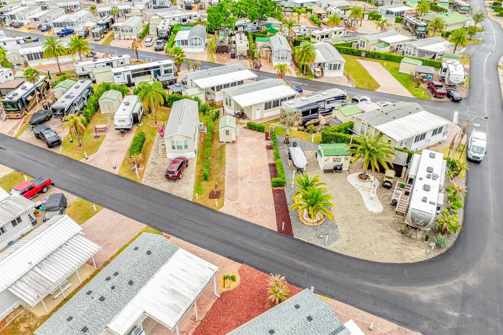 An aerial view shows a residential community with numerous mobile homes, driveways, and palm trees — 2410 LIMEWOOD AVENUE UNIT 304, CLERMONT, FL