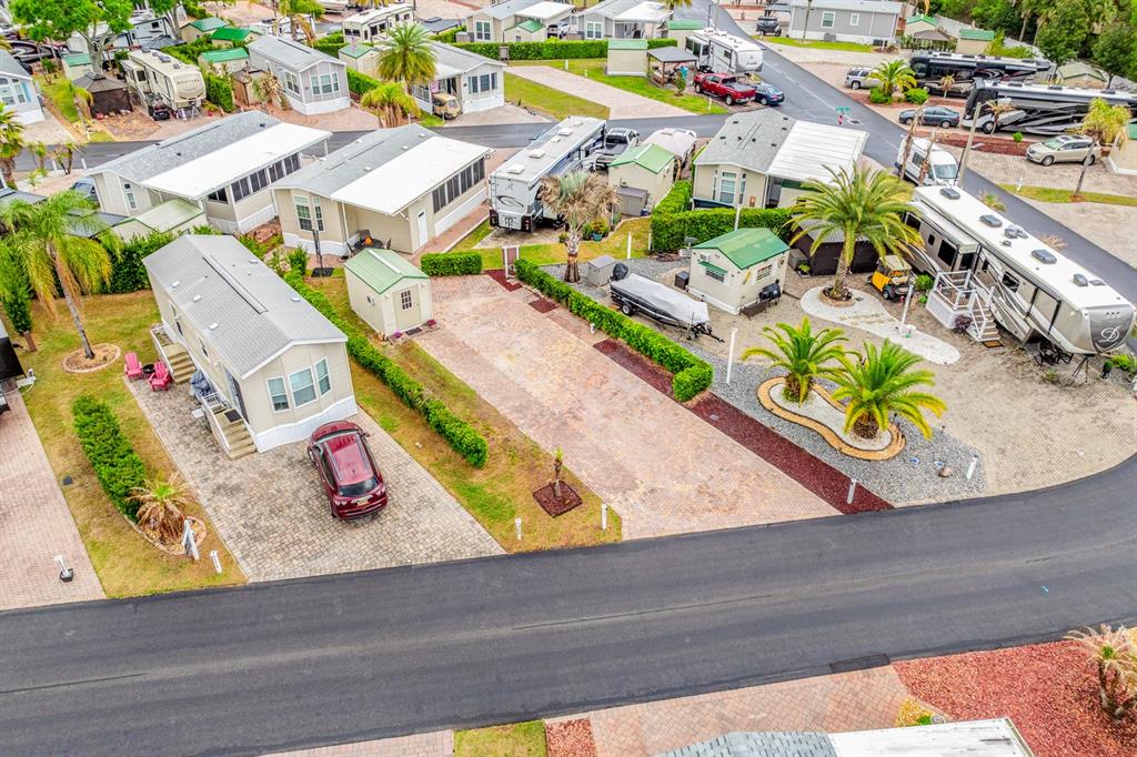 An aerial view shows several mobile homes, paved driveways, and palm trees in a park — 2410 LIMEWOOD AVENUE UNIT 304, CLERMONT, FL